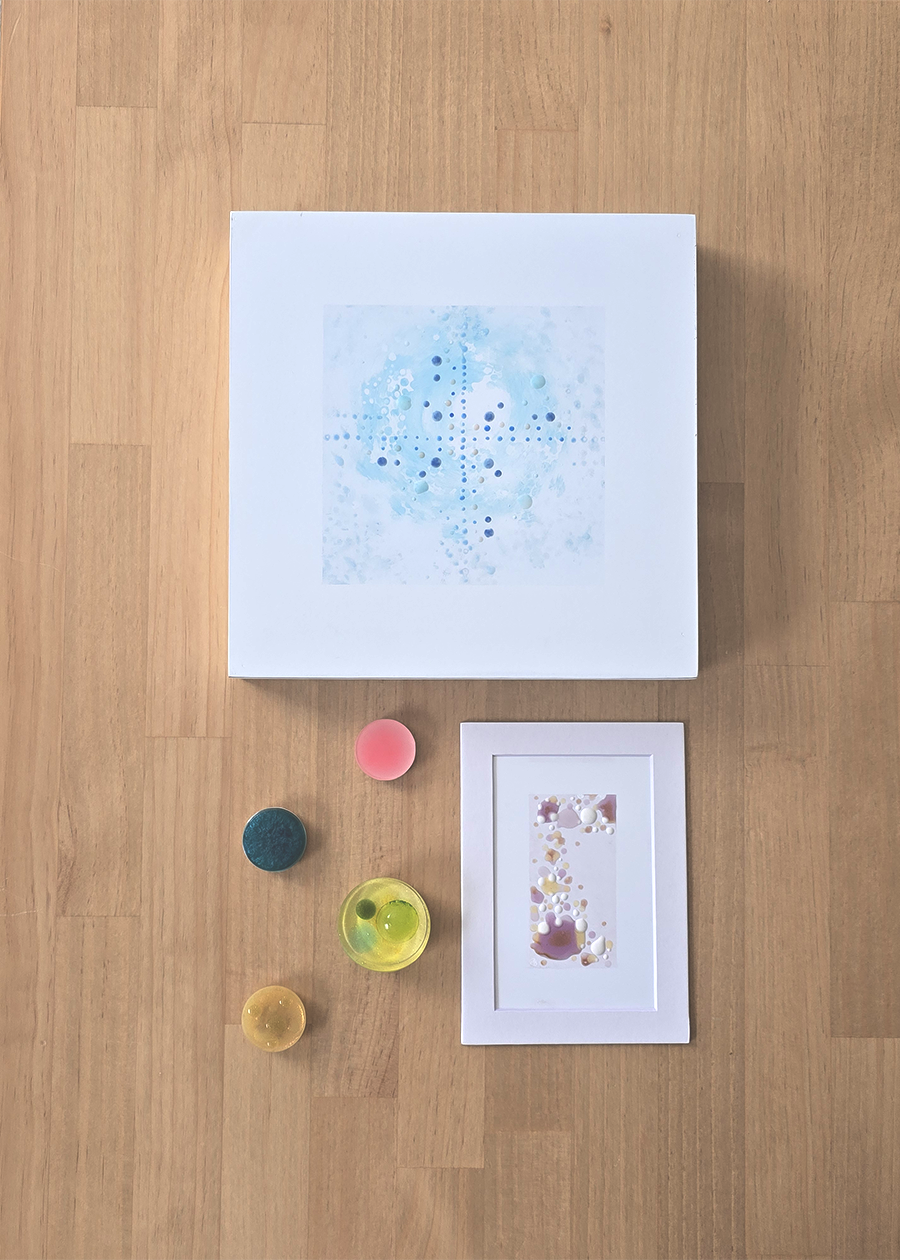 A collection of Dot artworks in various sizes on a wooden tabletop.