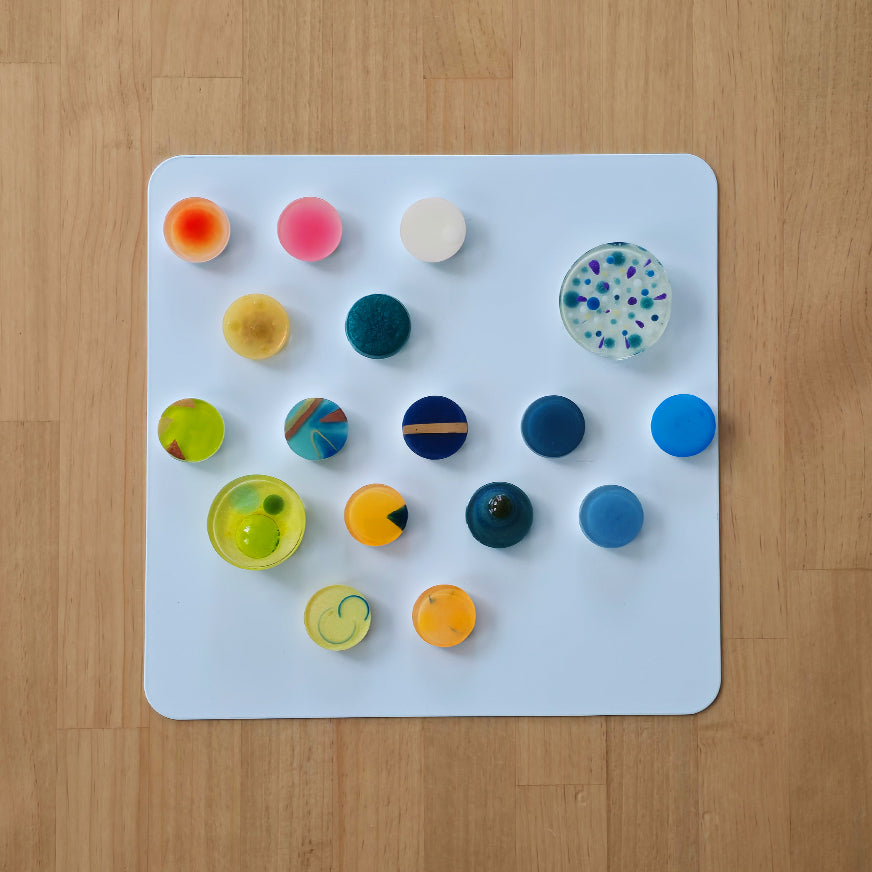 Collection of small resin studies exploring pigment layering, transparency, and optical depth through experimental casting techniques.