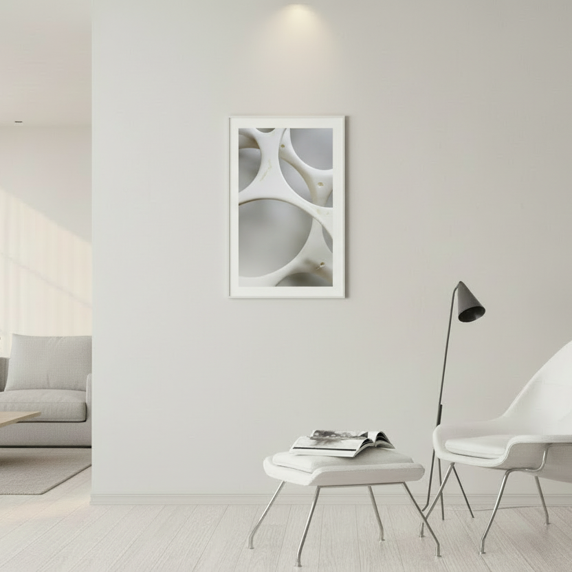 Modern living room with a white chair, coffee table, and abstract wall art.