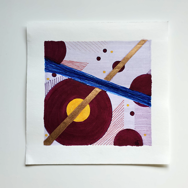An abstract square art print with geometric shapes, including maroon circles, a blue brushstroke, a copper diagonal line, and a yellow center, presented on a white paper square against a light gray background.