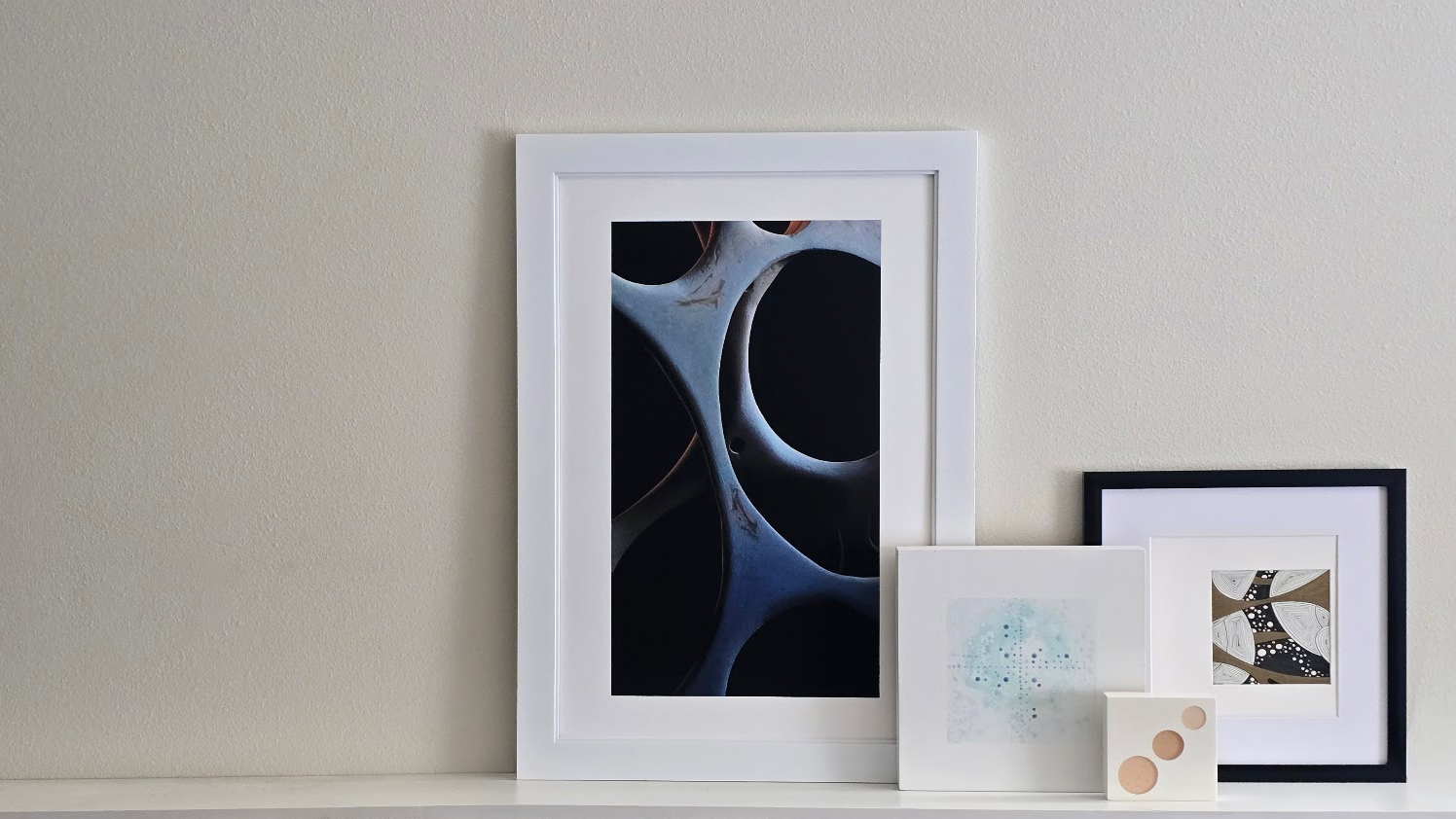 Framed artwork on a white surface with a neutral background