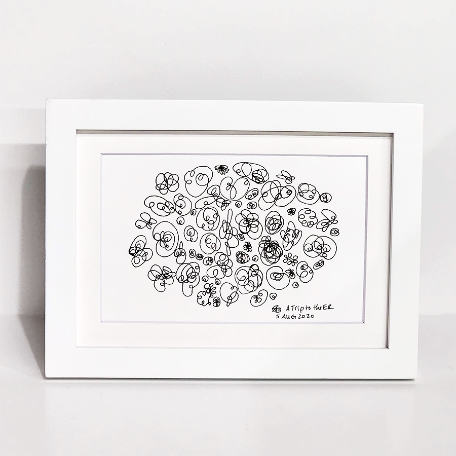 A framed black and white abstract line drawing on a white mat, set in a white frame and photographed against a light gray background.