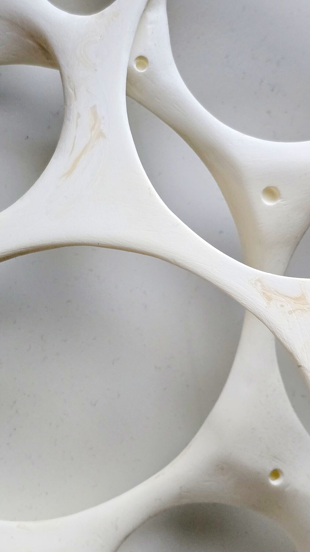 Minimal abstract wall artwork exploring balance and containment through layered circular light filled forms