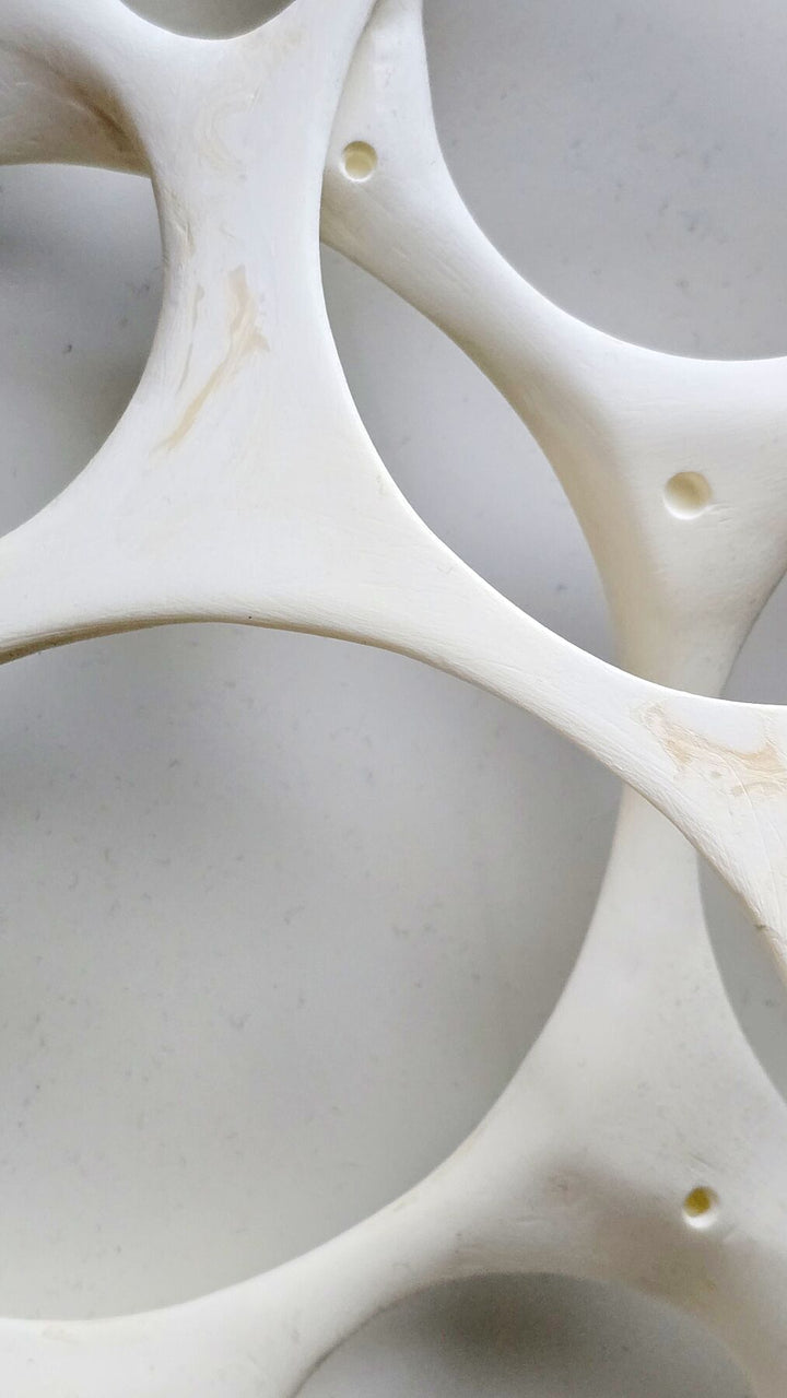 Minimal abstract wall artwork exploring balance and containment through layered circular light filled forms
