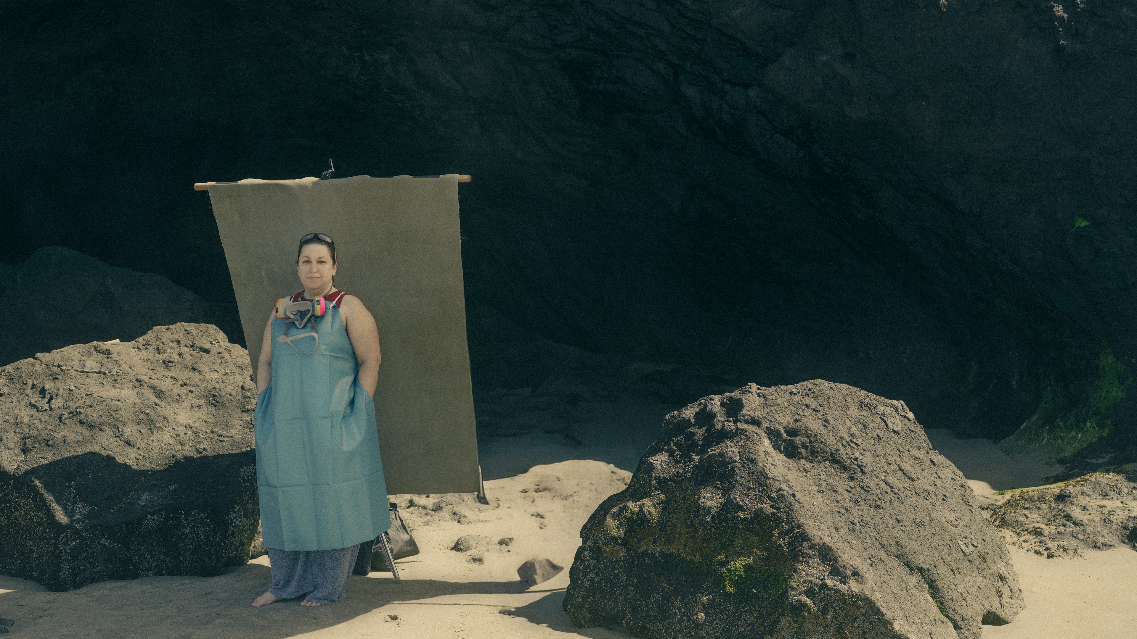 Ava Bock wearing studio safety equipment including ppe safety gear during an environmental portrait session on the Oregon coast, reflecting her sustainable resin art practice.